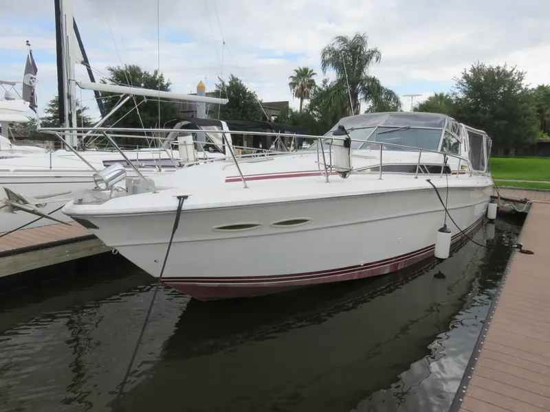 The Image of 1990 Sea Ray 390 Express Cruiser docked at marina. - 0