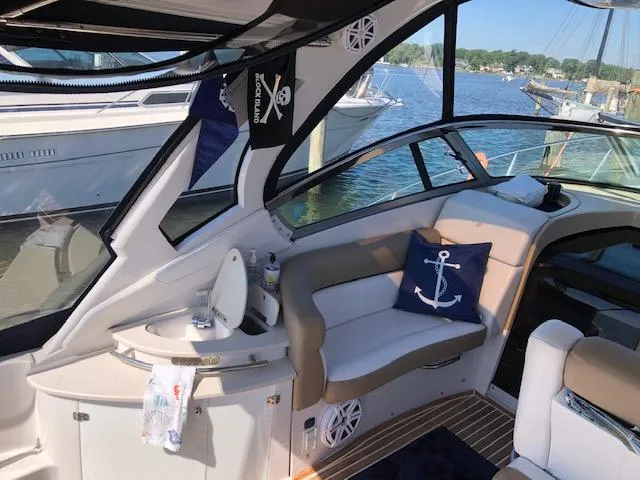 Slide: The Image of Interior of a 2014 Four Winns 355V boat with nautical decor and lake view. - 13