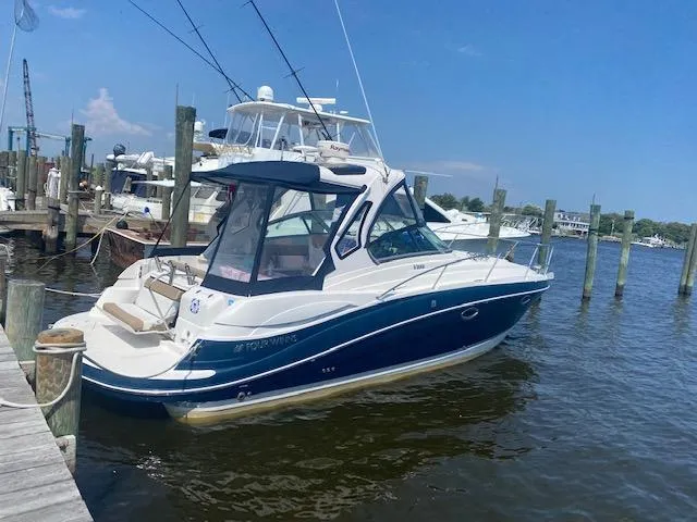 Slide: The Image of 2014 Four Winns 355V boat docked at a marina on a sunny day. - 2
