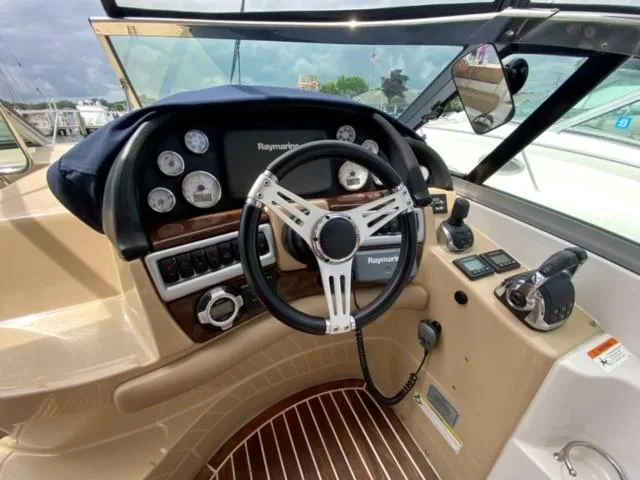 Slide: The Image of 2014 Four Winns 355V boat helm with Raymarine electronics and modern controls. - 29