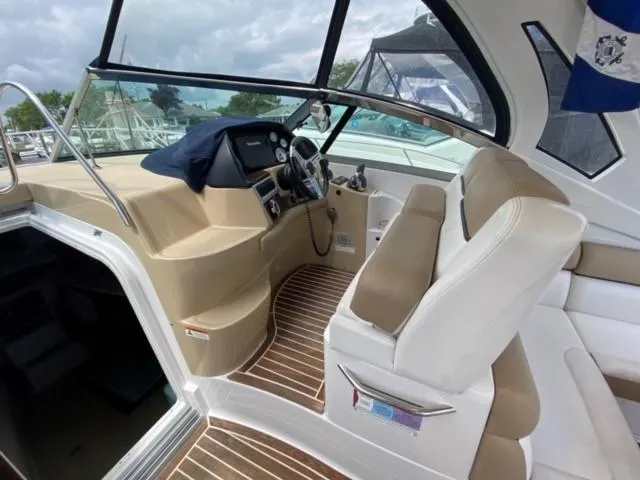 Slide: The Image of 2014 Four Winns 355V boat interior with helm, seating, and wood flooring. - 30