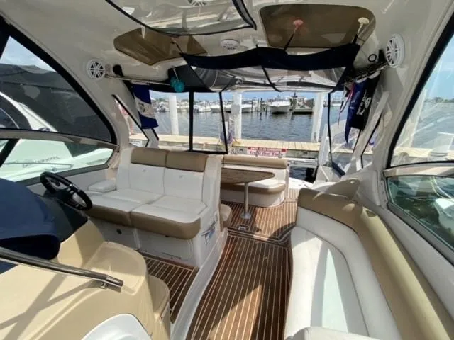 Slide: The Image of Interior of 2014 Four Winns 355V boat with seating and table, docked at marina. - 32