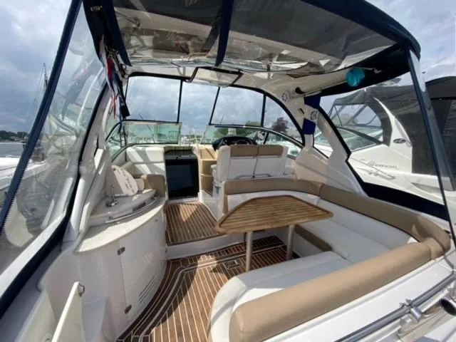 Slide: The Image of Interior of 2014 Four Winns 355V boat with seating and wooden table. - 34