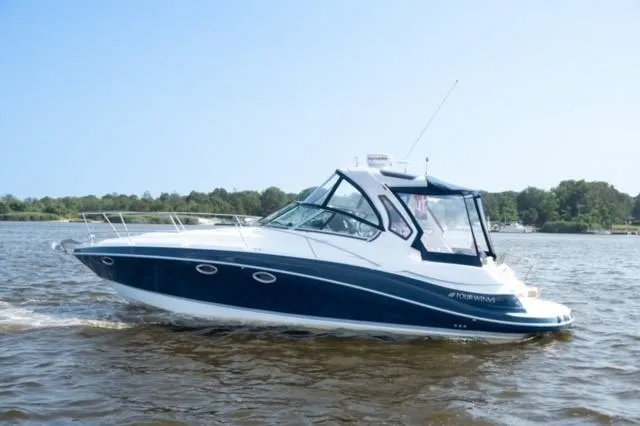 Slide: The Image of 2014 Four Winns 355V boat cruising on a lake. - 39