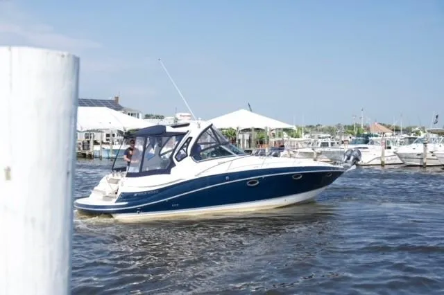 Slide: The Image of 2014 Four Winns 355V boat cruising in a marina on a sunny day. - 41