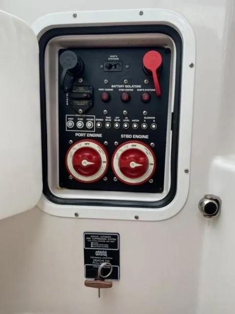 Slide: The Image of Control panel of a 2014 Four Winns 355V boat with battery isolators and engine switches. - 42