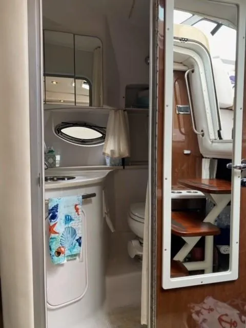 Slide: The Image of 2014 Four Winns 355V boat interior bathroom with sink and toilet. - 46