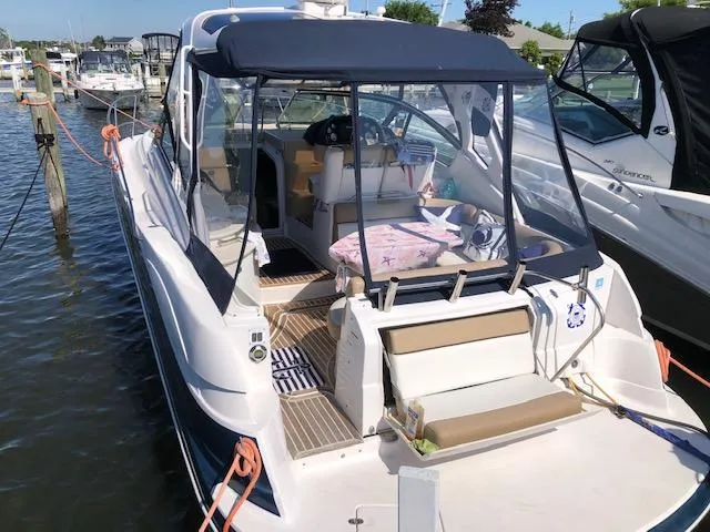 Slide: The Image of 2014 Four Winns 355V boat docked at marina, rear view. - 7