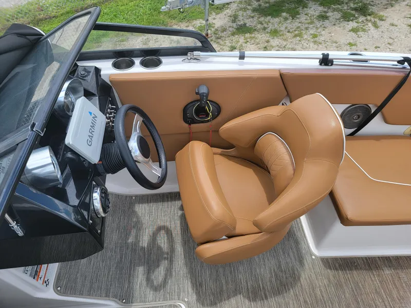 Slide: The Image of 2019 Glastron GTD 220 boat interior with tan leather seats and Garmin navigation system. - 11