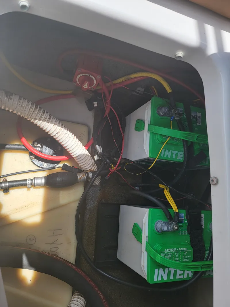 Slide: The Image of 2019 Glastron GTD 220 boat battery compartment with Interstate batteries. - 16