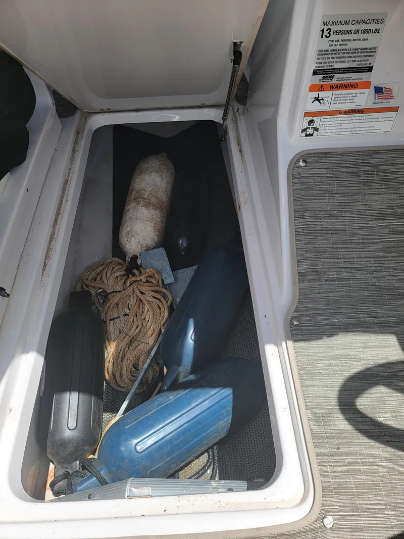 Slide: The Image of Storage compartment of a 2019 Glastron GTD 220 boat with boating equipment. - 17