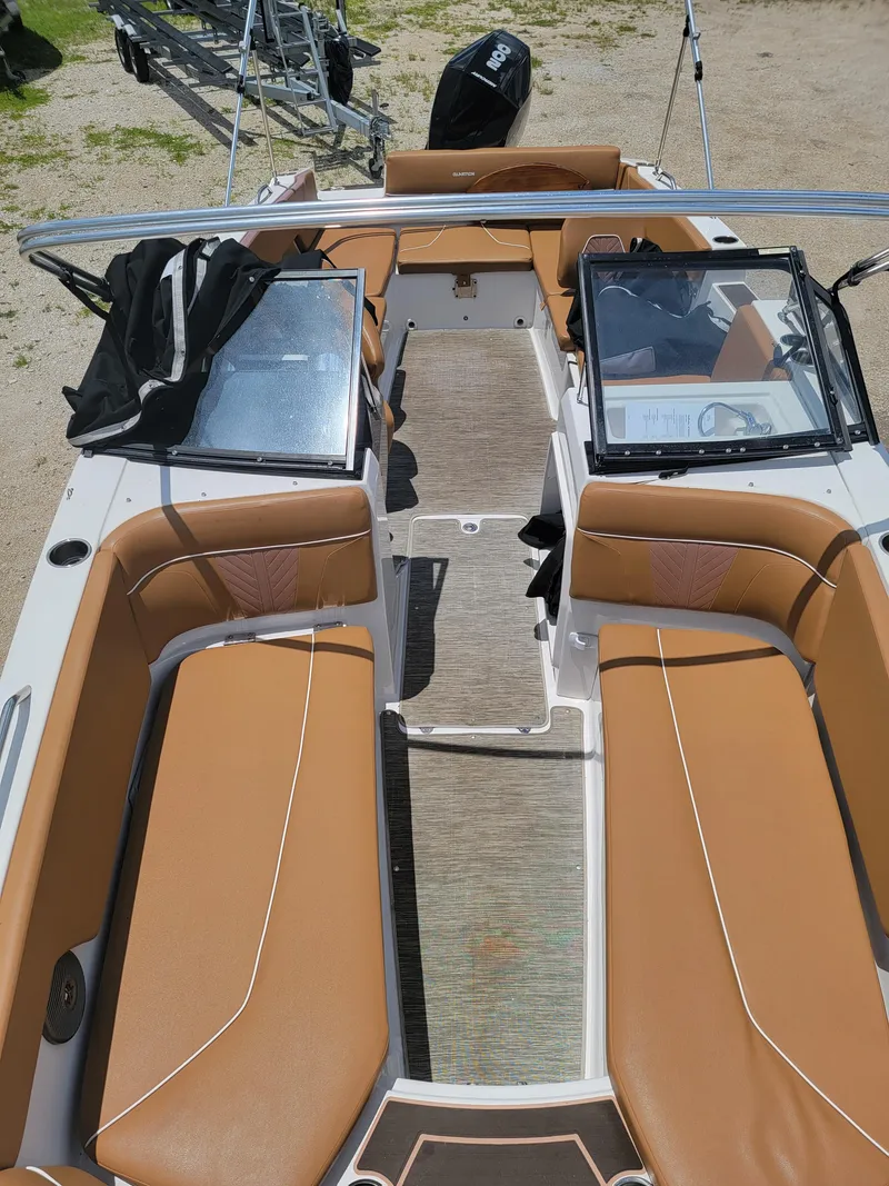 Slide: The Image of 2019 Glastron GTD 220 boat interior with tan seating and open deck. - 21