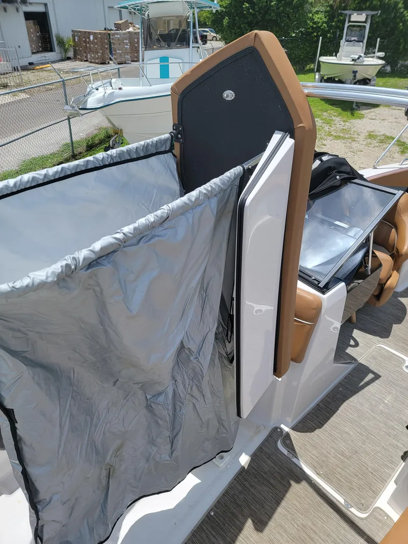Slide: The Image of 2019 Glastron GTD 220 boat interior with storage compartments and seating. - 22
