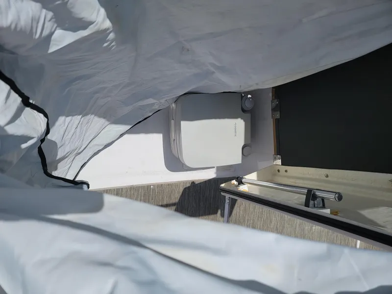 Slide: The Image of 2019 Glastron GTD 220 boat interior with covered seating area. - 23