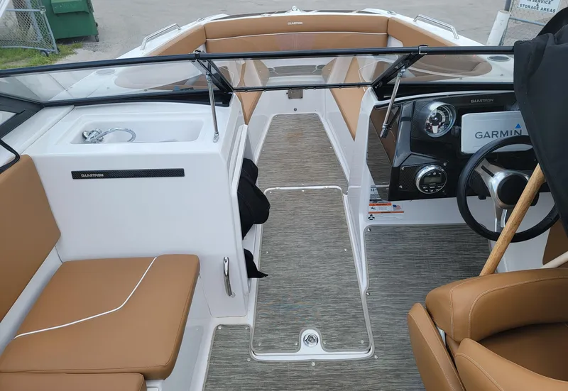 Slide: The Image of 2019 Glastron GTD 220 boat interior with tan seating and Garmin navigation system. - 26