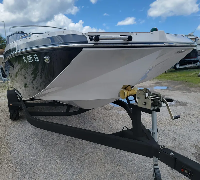 Slide: The Image of 2019 Glastron GTD 220 boat on trailer under a blue sky. - 29