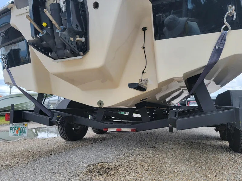 Slide: The Image of 2019 Glastron GTD 220 boat on trailer, rear view showing outboard motor and trailer hitch. - 31