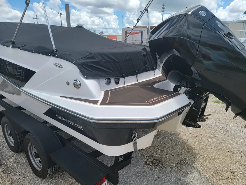 Slide: The Image of 2019 Glastron GTD 220 boat with outboard motor and black cover. - 8