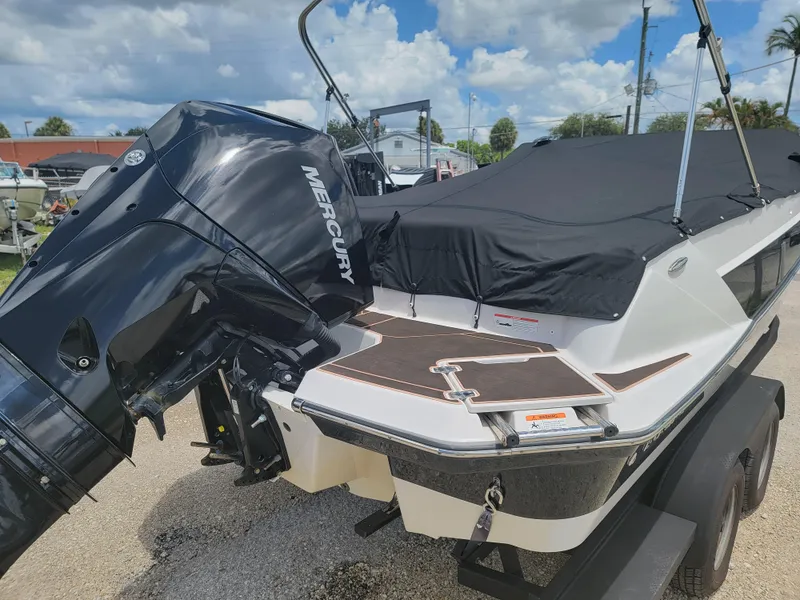 Slide: The Image of 2019 Glastron GTD 220 boat with Mercury outboard motor, covered and on a trailer. - 9