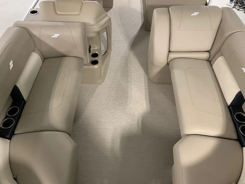 Slide: The Image of 2024 Starcraft LX22 R boat interior with beige seating and cup holders. - 15