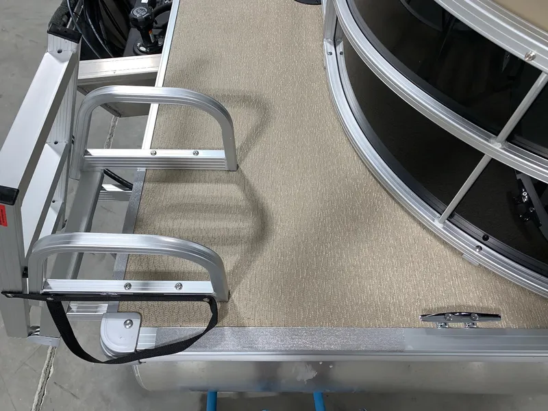 Slide: The Image of 2024 Starcraft LX22 R boat deck with aluminum ladder and carpeted flooring. - 3