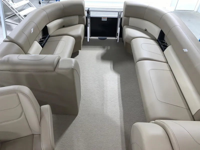 Slide: The Image of 2024 Starcraft LX22 R pontoon boat interior with beige seating and cup holders. - 8