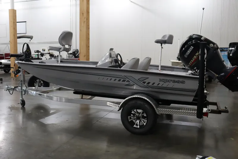 Slide: The Image of 2023 Xpress H17 boat on trailer in indoor showroom. - 1