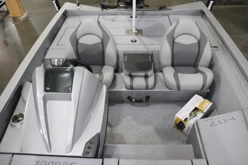 Slide: The Image of 2023 Xpress H17 boat interior with dual gray seats and console. - 5