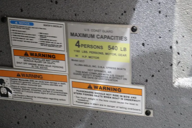 Slide: The Image of 2023 Xpress H17 boat capacity and safety warning labels. - 8