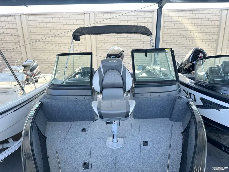 Slide: The Image of 2022 Lund 1875 Impact XS boat interior with seating and windshield. - 3