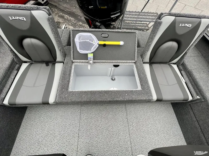 Slide: The Image of 2022 Lund 1875 Impact XS boat interior with seating and storage compartment. - 4