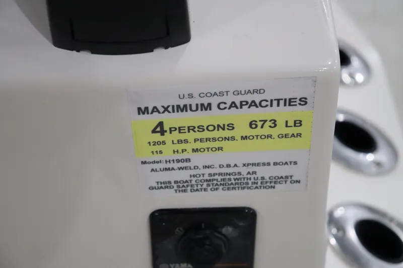 Slide: The Image of 2023 Xpress H190 Bay boat capacity label, 4 persons, 673 lbs, 115 HP motor. - 10