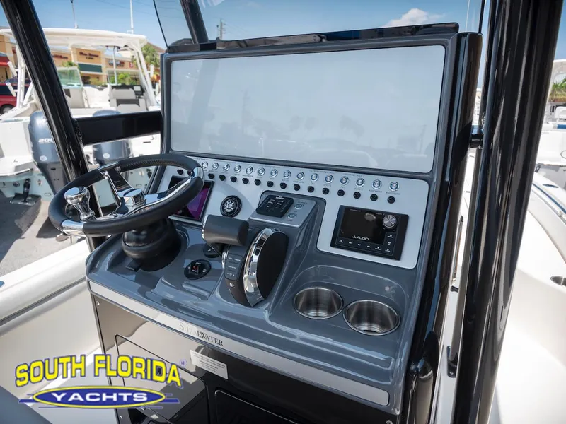 Slide: The Image of 2023 ShearWater 260 Carolina boat console with steering wheel and controls, South Florida Yachts. - 19