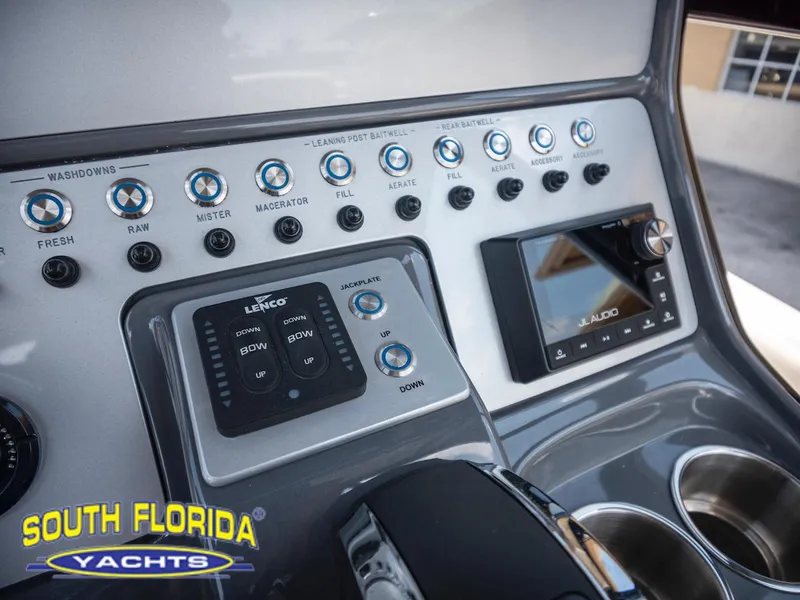 Slide: The Image of Control panel of 2023 ShearWater 260 Carolina boat with various switches and display. - 23