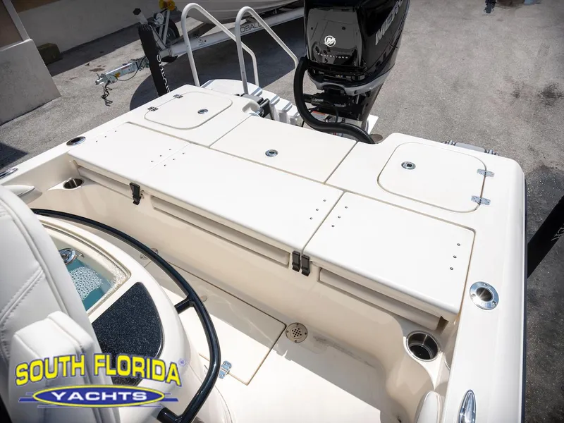 Slide: The Image of 2023 ShearWater 260 Carolina boat deck with storage compartments and motor, South Florida Yachts. - 25