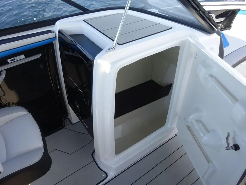 Slide: The Image of 2020 Yamaha Boats 242 X interior storage compartment with open door. - 14