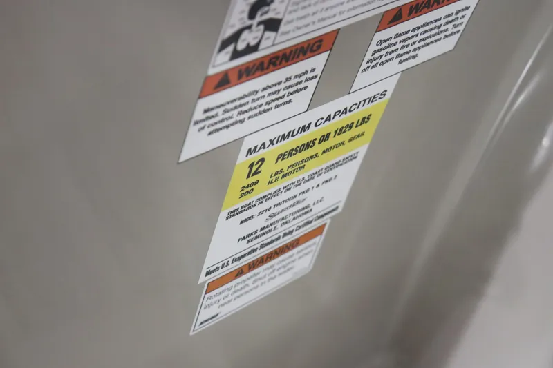 Slide: The Image of Warning and capacity labels on 2023 Silver Wave 2210 SW5 RLP boat. - 10