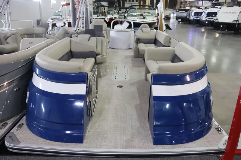 Slide: The Image of 2023 Silver Wave 2210 SW5 RLP pontoon boat with blue and white exterior, beige seating. - 4