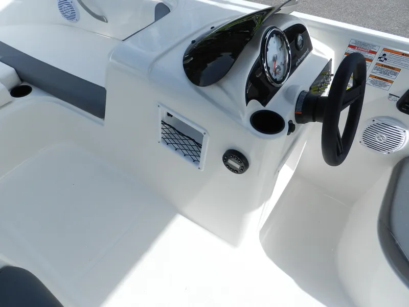 Slide: The Image of 2025 Bayliner E18 boat dashboard with steering wheel and instrument panel. - 14