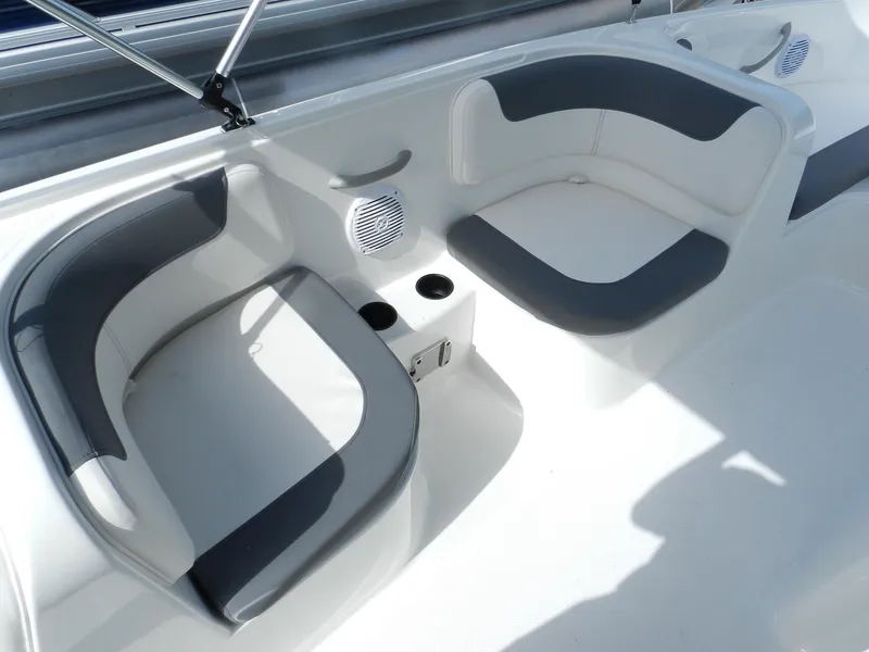 Slide: The Image of 2025 Bayliner E18 boat interior with gray and white seating. - 16