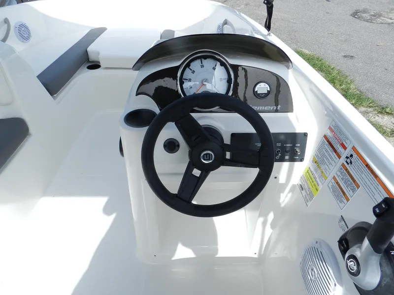 Slide: The Image of 2025 Bayliner E18 boat dashboard with steering wheel and gauges. - 17
