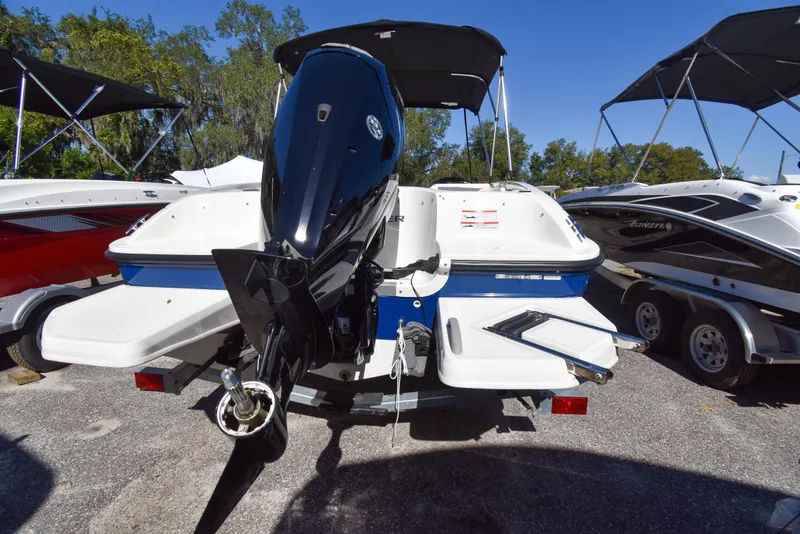 Slide: The Image of 2025 Bayliner E18 boat with outboard motor, parked on a trailer. - 3