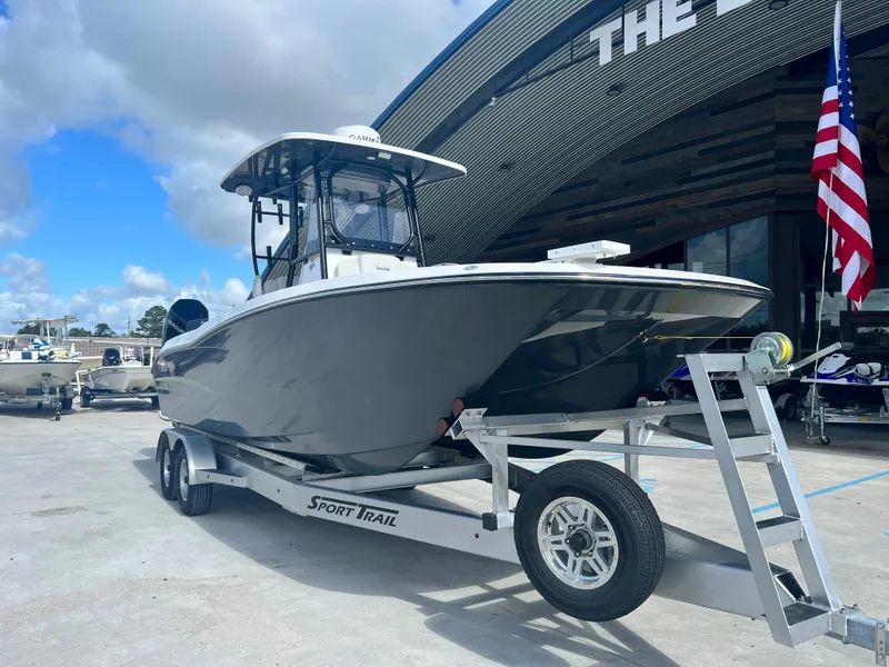 Slide: The Image of 2023 Sea Cat 262 HC boat on a Sport Trail trailer outside a dealership. - 2