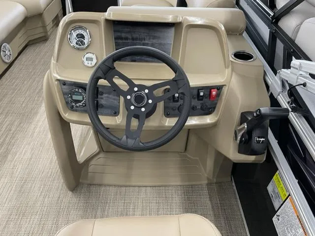 Slide: The Image of 2023 Starcraft LX 16 R boat dashboard with steering wheel and control panel. - 10