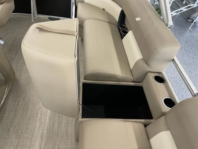 Slide: The Image of 2023 Starcraft LX 16 R boat interior with beige seating and storage compartments. - 12