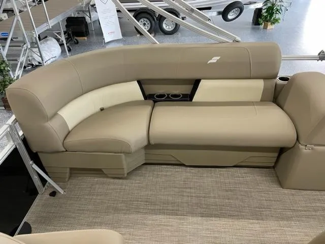 Slide: The Image of 2023 Starcraft LX 16 R boat interior with beige seating and cup holders. - 13