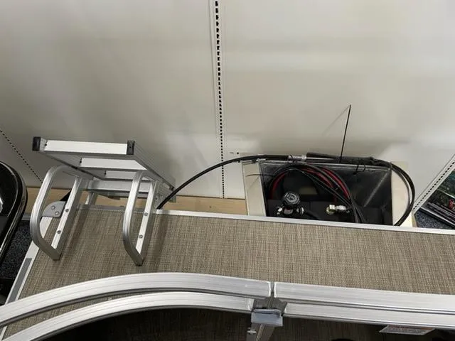 Slide: The Image of 2023 Starcraft LX 16 R boat interior with ladder and storage compartment. - 14