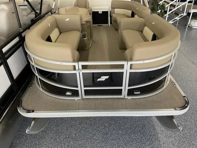Slide: The Image of 2023 Starcraft LX 16 R pontoon boat with beige seating and spacious deck. - 2