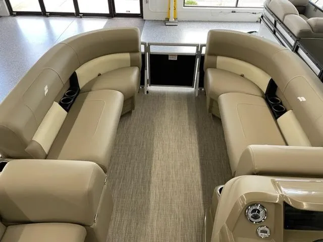 Slide: The Image of 2023 Starcraft LX 16 R pontoon boat interior with beige seating and carpet. - 4
