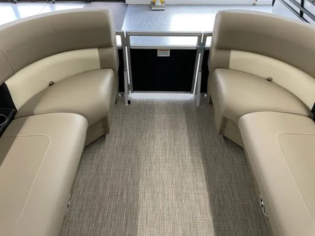 Slide: The Image of 2023 Starcraft LX 16 R boat interior with beige seating and carpeted floor. - 6